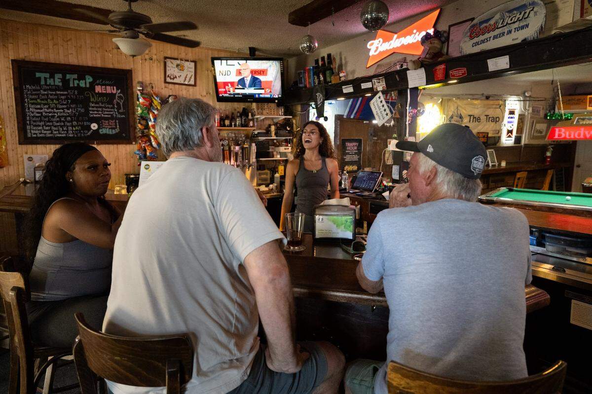 Mariah Lukenbill laughs with her customers at The Trap in Sacramento on Monday.