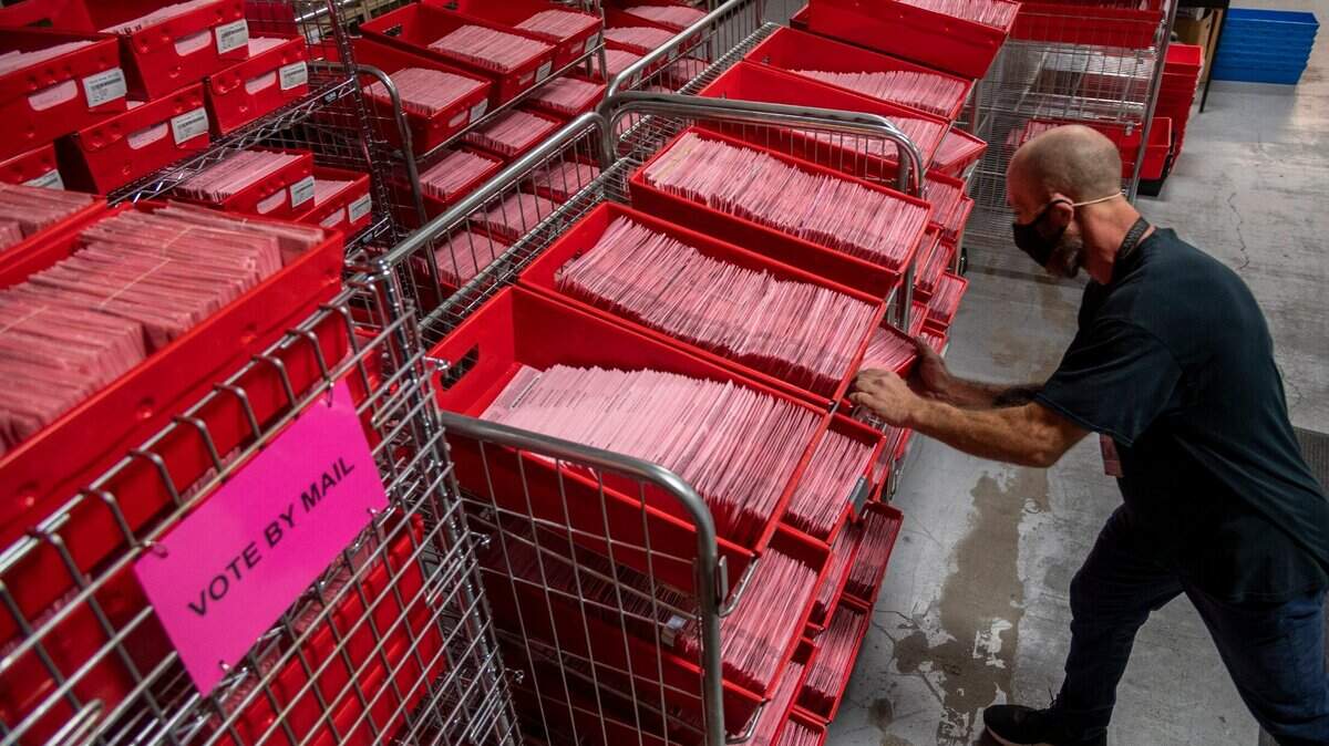 A worker sorts vote-by-mail ballots at the Sacramento County Voter Registration and Elections Office in November 2020.