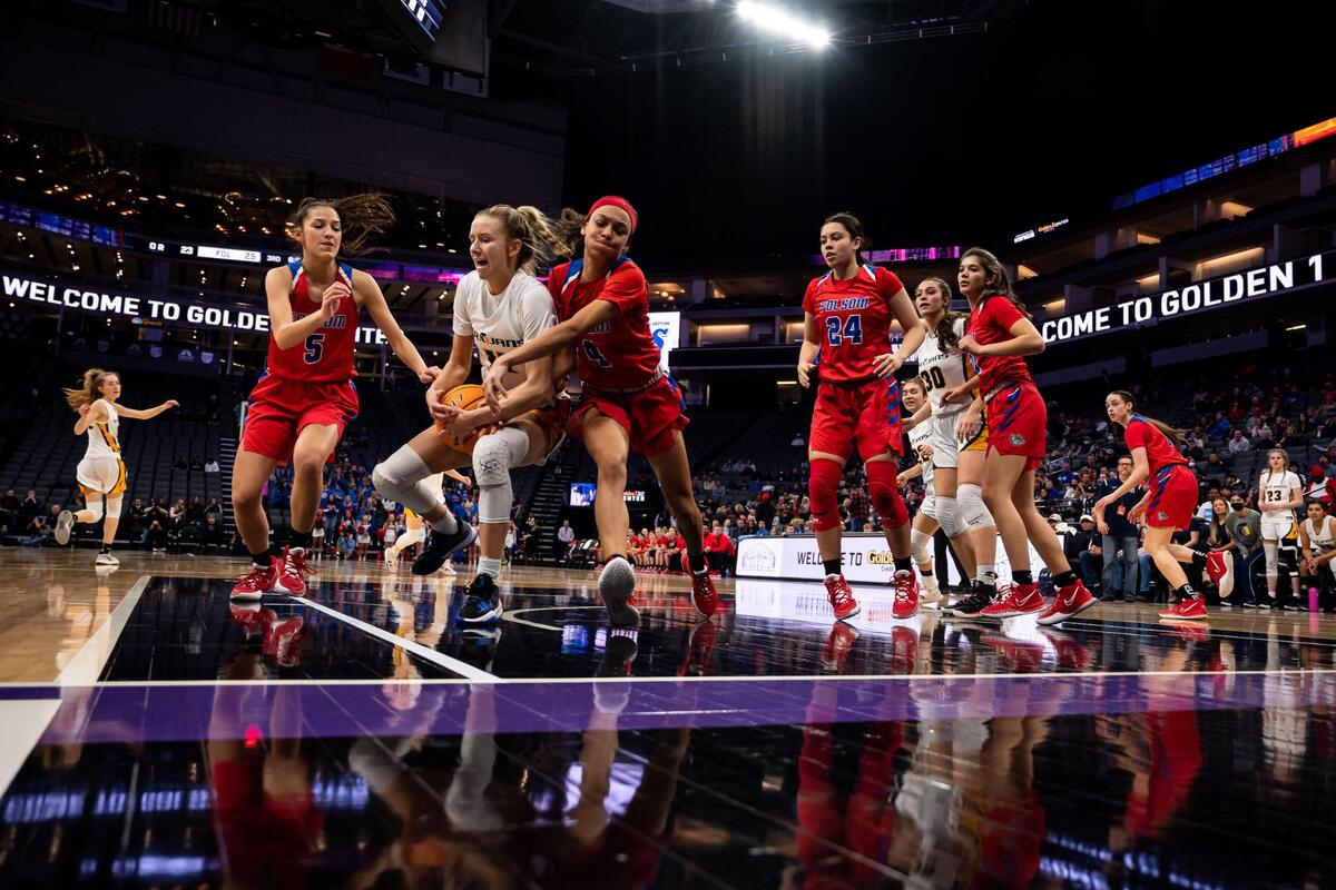 Oak Ridge Trojans’ Teagan Brown (11), left, and Folsom Bulldogs’ Makayla Jackson (4) fight for a rebound during the third period at the high school girls basketball Sac-Joaquin Section Division I championship game Saturday, Feb. 26, 2022, at Golden 1 Center in Sacramento. Oak Ridge edged past Folsom, 41-40, for the section title.