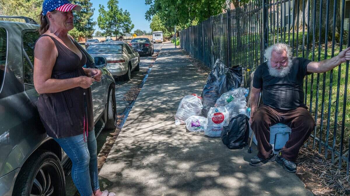 Jami Arbuckle, 52, left, sobs as she explains that her friend Donald Lowery, 73, right, is homeless and in bad health after being kicked out of a motel when he returned from the hospital recently, Monday June 14, 2021, in Sacramento.