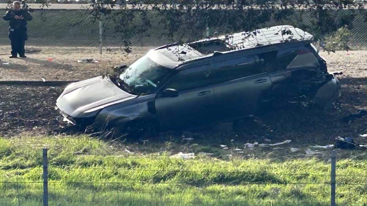 Marvin Morales’ SUV sits damaged after crashing down an embankment along Interstate 5 near Highway 12 in San Joaquin County on Dec. 2, 2025, following a high-speed chase with law enforcement. Morales, a former Sacramento sheriff's deputy, was shot and killed after he ran from police following the fatal stabbing of his son at the family's Elk Grove home.