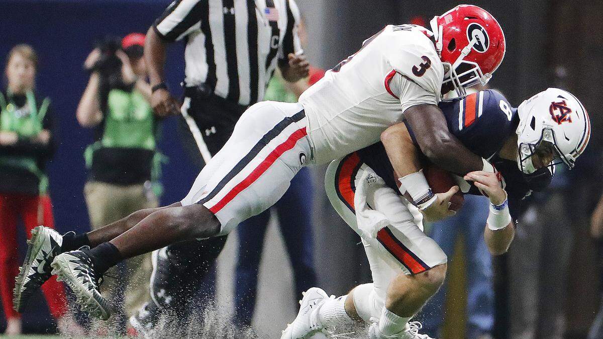Georgia linebacker Roquan Smith (3) tackles Auburn quarterback Jarrett Stidham (8) during the first half of the Southeastern Conference championship NCAA college football game on Saturday, Dec. 2, 2017, in Atlanta.