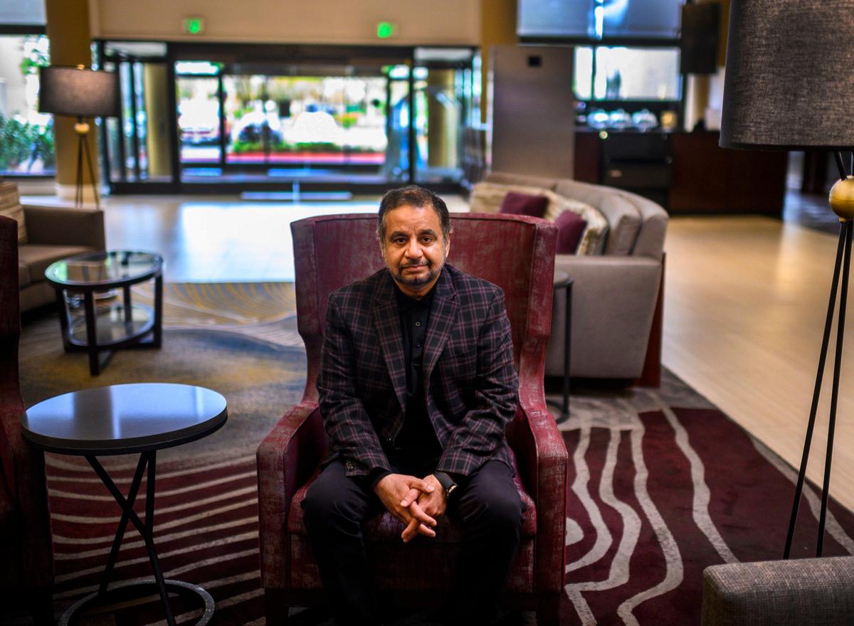 General Manager Sami Qureshi sits in the lobby at the Hilton Arden West in Sacramento, Thursday, March 26, 2020. “It’s been devastating to our business. Travelers have completely stopped traveling out of caution,” Qureshi said.
