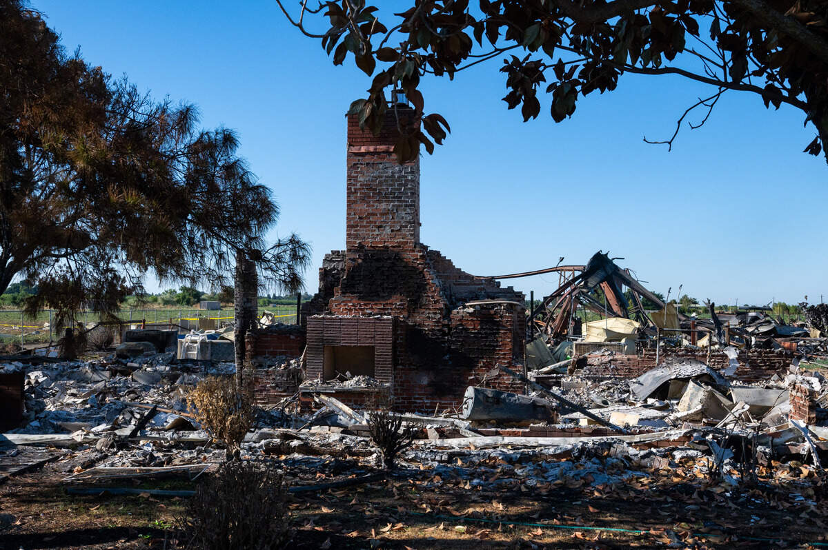 A chimney, all the remains of the demolished home at the Esparto fireworks explosion site, stands amid debris on Friday, July 18, 2025.