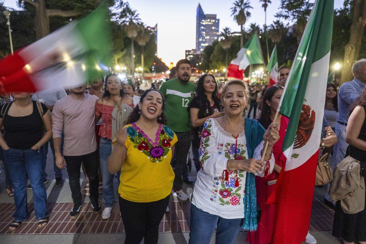Violeta Mesa Calderon and her mother Violeta Calderon join attendees as they sing “Mexico Lindo” at the state Capitol on Monday, the eve of Mexican Independence Day.