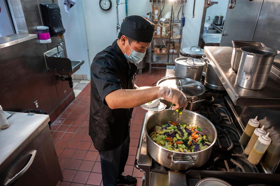 Sam Sang Zhu cooks vegetables in the kitchen on May 18. Sang Zhu said he makes something different every day so his menu is always changing.