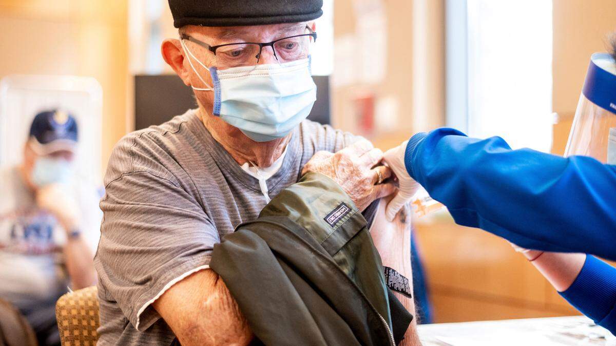 Jim Clark, 86, receives a first dose of Pfizer-BioNTech COVID-19 vaccine at UC Davis Medical Center on Tuesday, Jan. 12, 2021, in Sacramento.