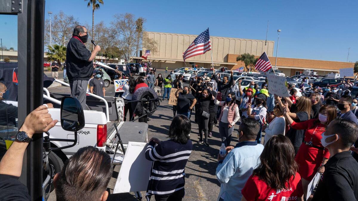 Community leaders and politicians speak to a crowd that gathered after multiple vehicle parades from around the city converged in a parking lot on Florin Road in south Sacramento for a rally against API hate, Saturday, March 27, 2021.