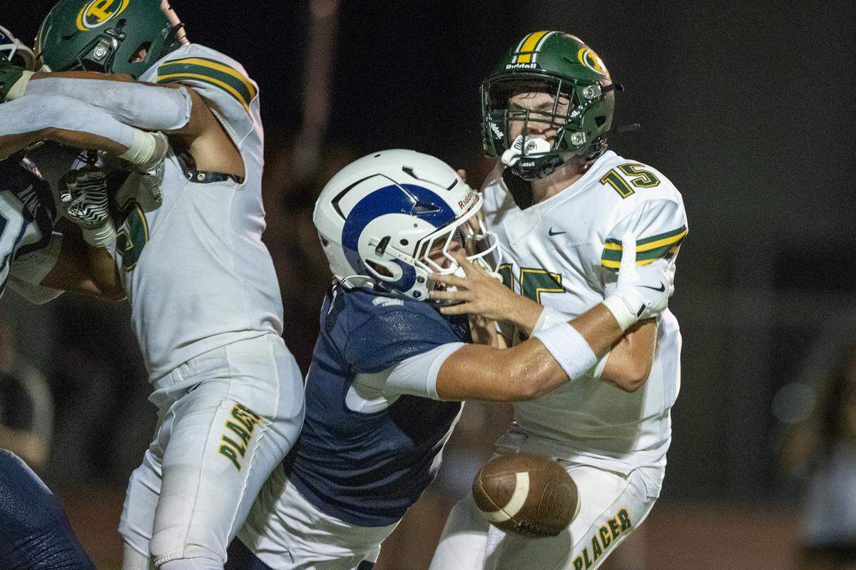 The Placer Hillmen's Liam Grant (15) is sacked by the Casa Roble Rams' Zander Freitag (4) as the Hillmen attempt a 2-point conversion in the first half on Friday in Orangevale.