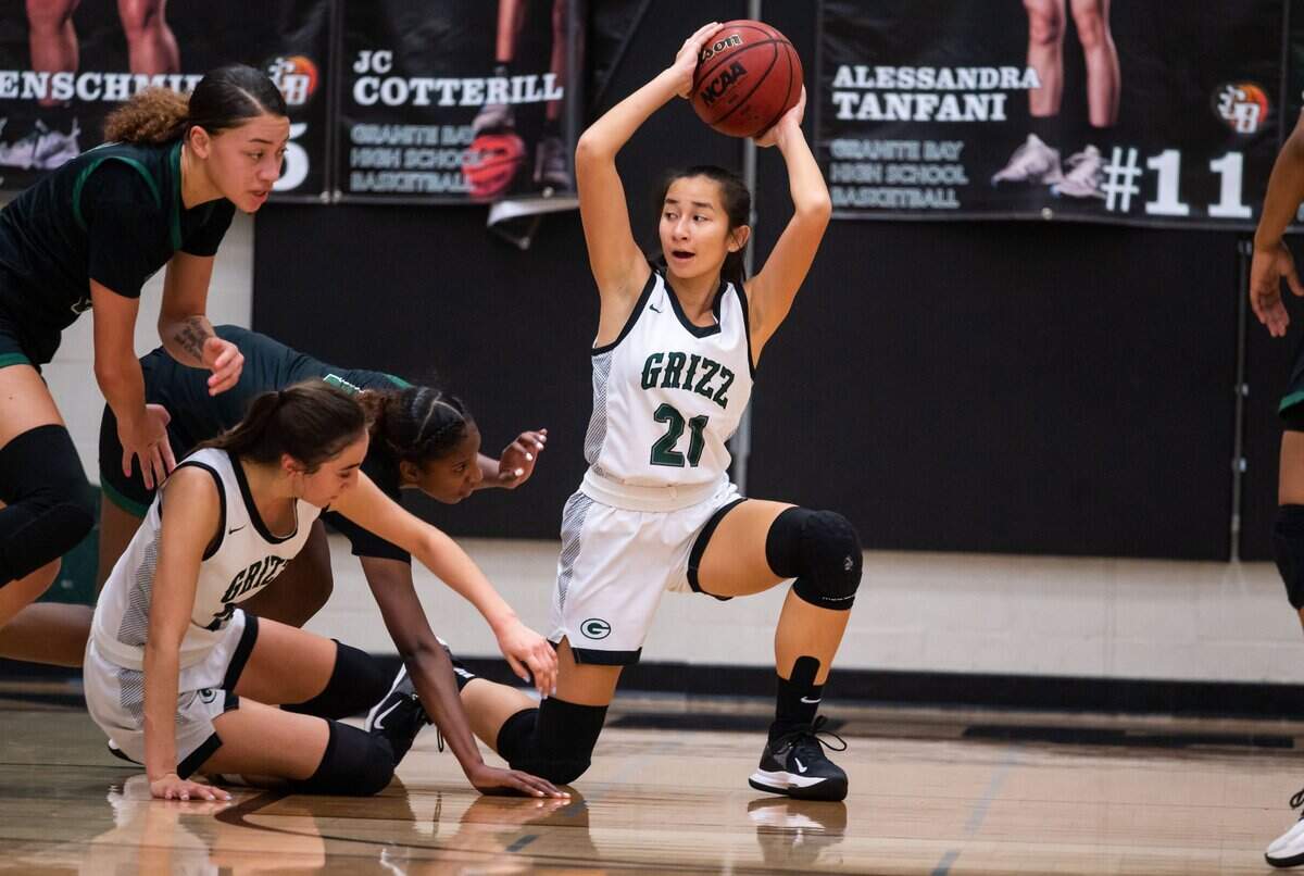 Granite Bay Grizzlies’ Kaylee Kittle (21) keeps control of the ball after an offensive recovery as they play against Rodriguez during the high school girls basketball Sac-Joaquin Section playoff game Thursday, Feb. 17, 2022, at Granite Bay High School. Rodriguez came from behind in the second half to beat Granite Bay, 57-50.