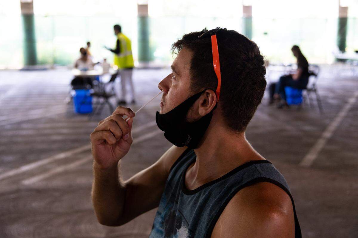 Sacramento State student Daniel Yaikov, 21, who is not vaccinated, takes a COVID-19 test on campus on Thursday, Sept. 16, 2021. Two tests per week are required for unvaccinated students.