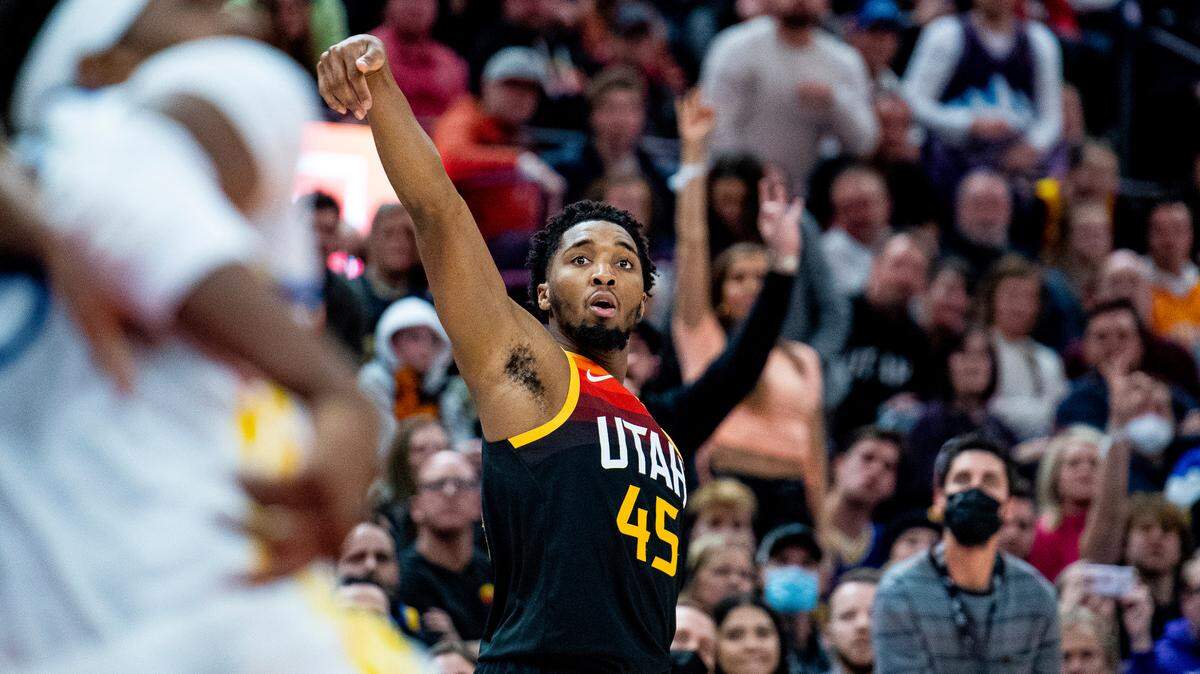 Utah Jazz guard Donovan Mitchell (45) holds his follow-through on his shot in the second half during an NBA basketball game against the Golden State Warriors on Saturday, Jan. 1, 2022, in Salt Lake City. (AP Photo/Isaac Hale)