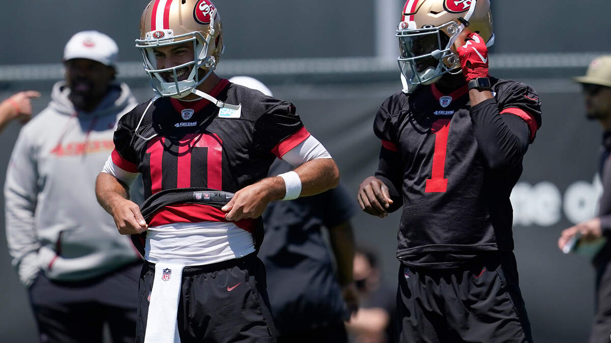 San Francisco quarterback Jimmy Garoppolo smiles next to quarterback Josh Johnson during the team’s workouts on May 25, 2021.