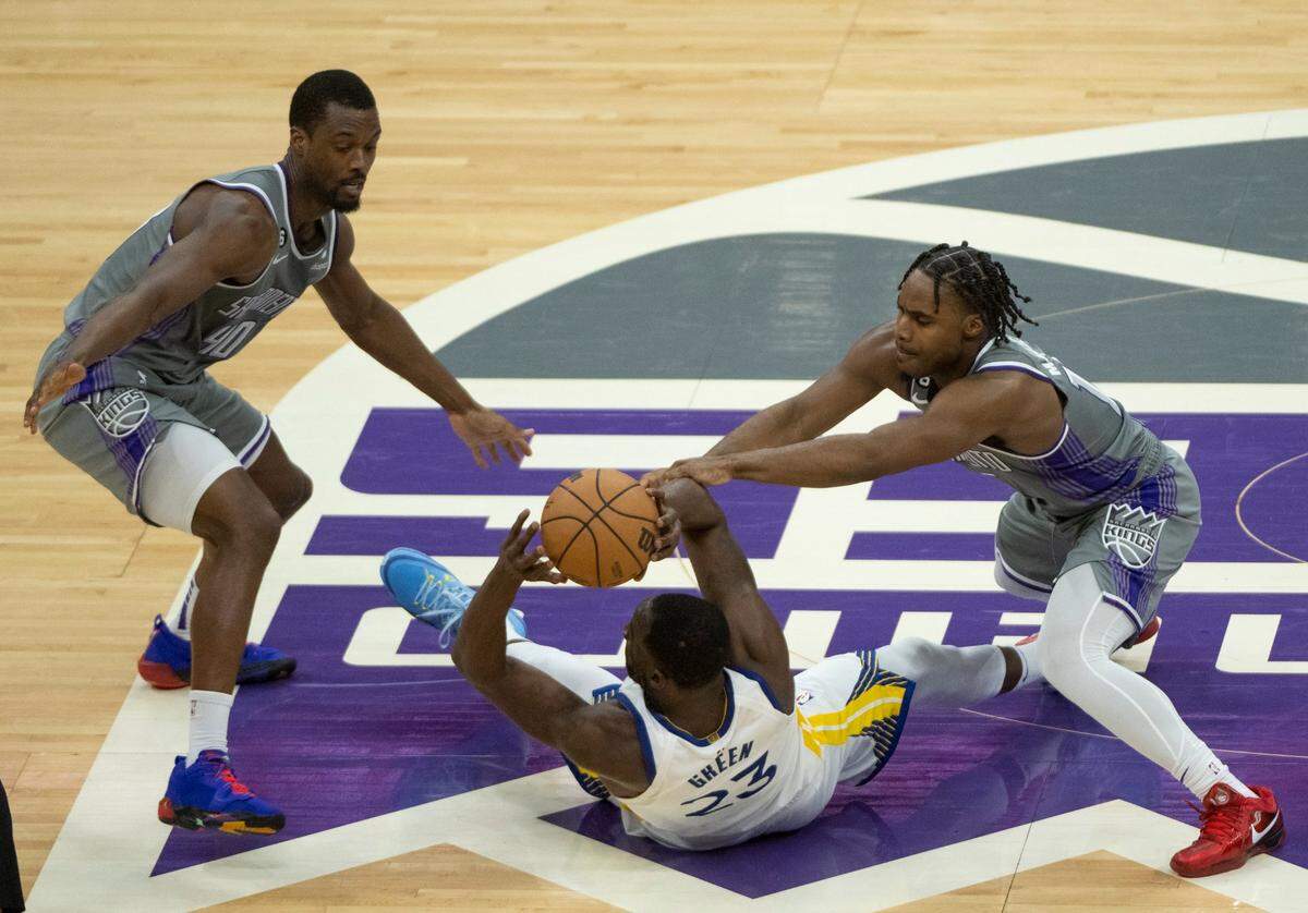 Sacramento Kings forward Harrison Barnes (40) and guard Davion Mitchell (15) battle Golden State Warriors forward Draymond Green (23) for the ball during Game 5 of the first-round NBA playoff series at Golden 1 Center on Wednesday, April 26, 2023.