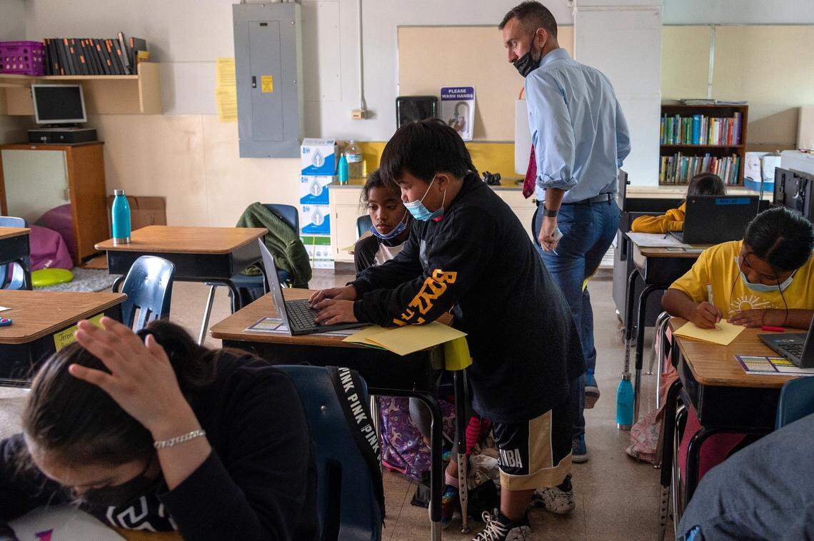 Principal Nate McGill of Ethel I. Baker Elementary School darts around third grade students as they make welcome home cards on Oct. 22 in anticipation of the return of three students from Afghanistan.