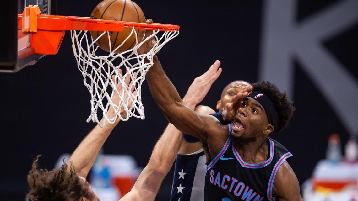 Sacramento Kings forward Terence Davis (9) dunks the ball with force as Washington Wizards guard Russell Westbrook (4) makes contact from behind, and center Robin Lopez (15) defends at left, during the fourth period of the NBA game Wednesday, April 14, 2021, at Golden 1 Center in downtown Sacramento. A delay of game was called against the Kings after the play on the way to the Wizards’ 123-111 win.
