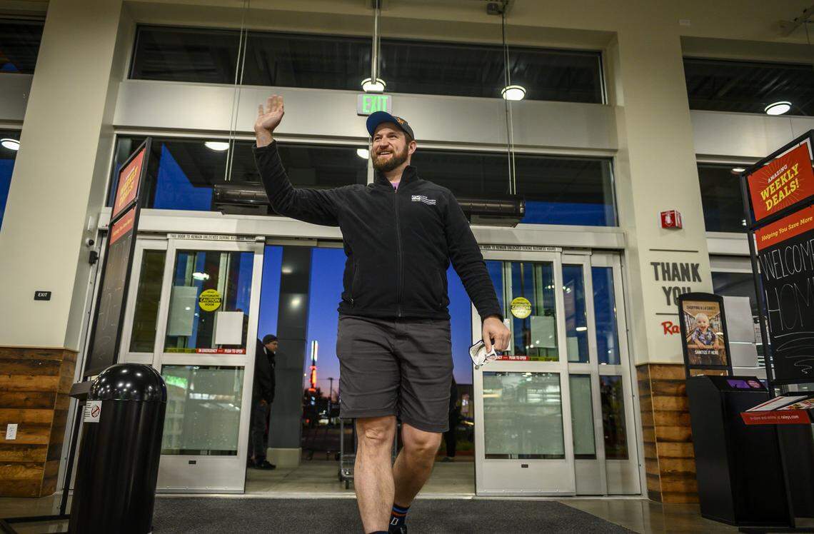 City Counciman Steve Hansen waves to the staff while entering the Raley’s in South Land Park. Hansen was the first customer to enter the store.