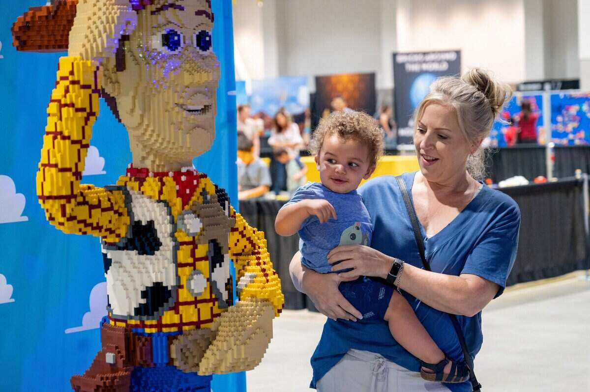 Beth Clark holds her grandson Fawkes, 1, while they look at the Lego Woody on display at the Brick Fest Live on Sunday, Oct. 2, 2022, at SAFE Credit Union Convention Center in downtown Sacramento.