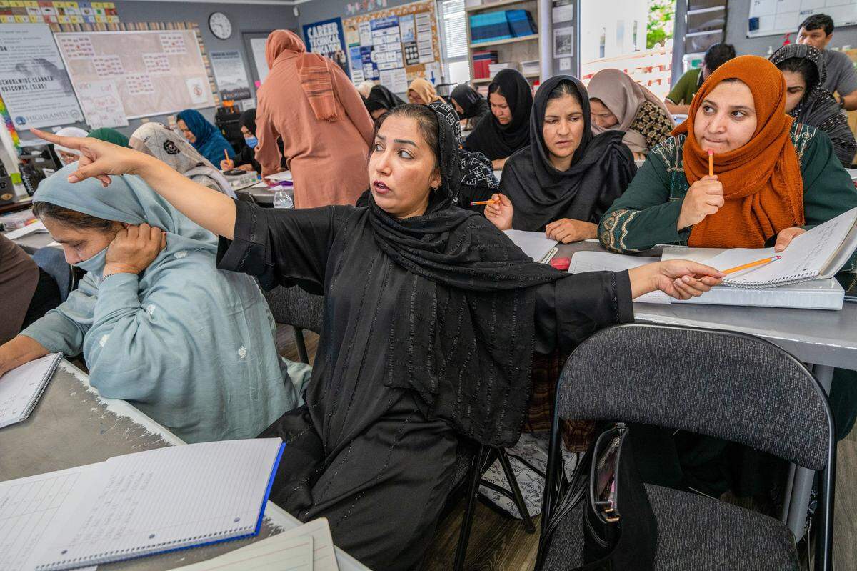 Afghan student Diba Bakhshi Kargar, 28, helps another student with her English lesson at Highlands Community Charter’s Edison Avenue campus in Arden Arcade last month. Bakhshi Kargar said her entire class began crying when their teacher announced the school might close. “It’s my last wish that the school should not be closed,” she said.