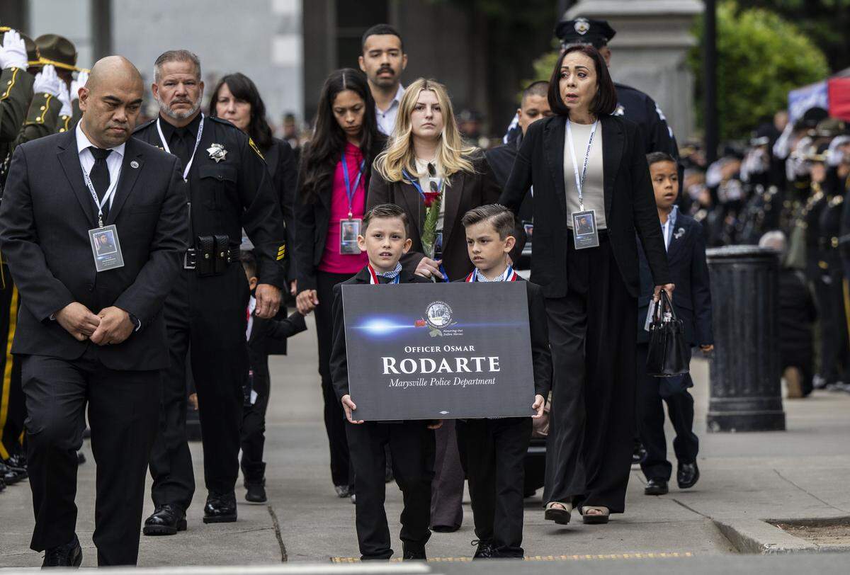 Family members of fallen Marysville Police Officer Osmar Rodarte walk to the California Peace Officers’ Memorial during the enrollment ceremony in Sacramento on Monday.