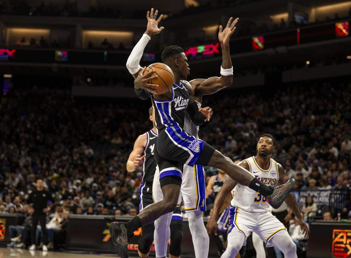Sacramento Kings guard Dennis Schroder (17) looks to make a pass during an NBA game against the Los Angeles Lakers at Golden 1 Center on Sunday.