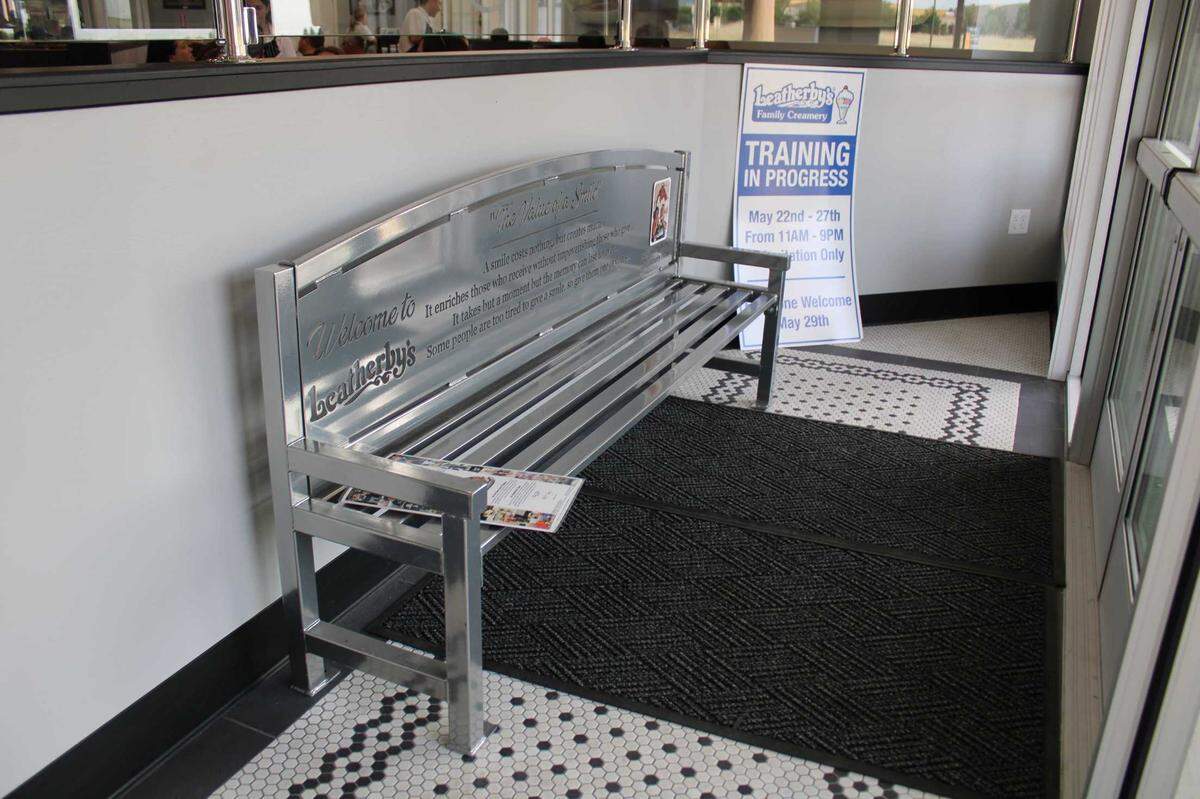 The Folsom-unique bench that Dave Leatherby Jr. had made in memory of his father sits in the foyer of the ice cream parlor’s newest location on Monday, May 22, 2023. Four lines from the poem, “The Value of a Smile,” are inscribed into the seat’s back. Leatherby said his father, Daddy Dave, often recited it.
