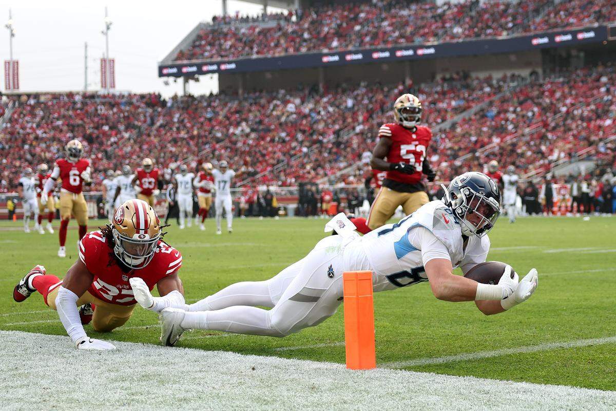 Gunnar Helm, No. 84 of the Tennessee Titans dives, into the end zone for a touchdown against the San Francisco 49ers during the second quarter at Levi's Stadium on December 14, 2025 in Santa Clara.