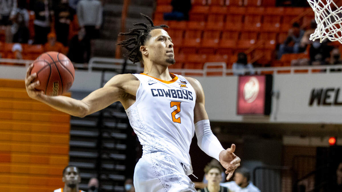 In this Dec. 5, 2020, file photo, Oklahoma State’s Cade Cunningham dunks the ball against Oakland in Stillwater, Okla. Cunningham was The Associated Press Big 12 newcomer of the year and is expected to be a top NBA draft pick.