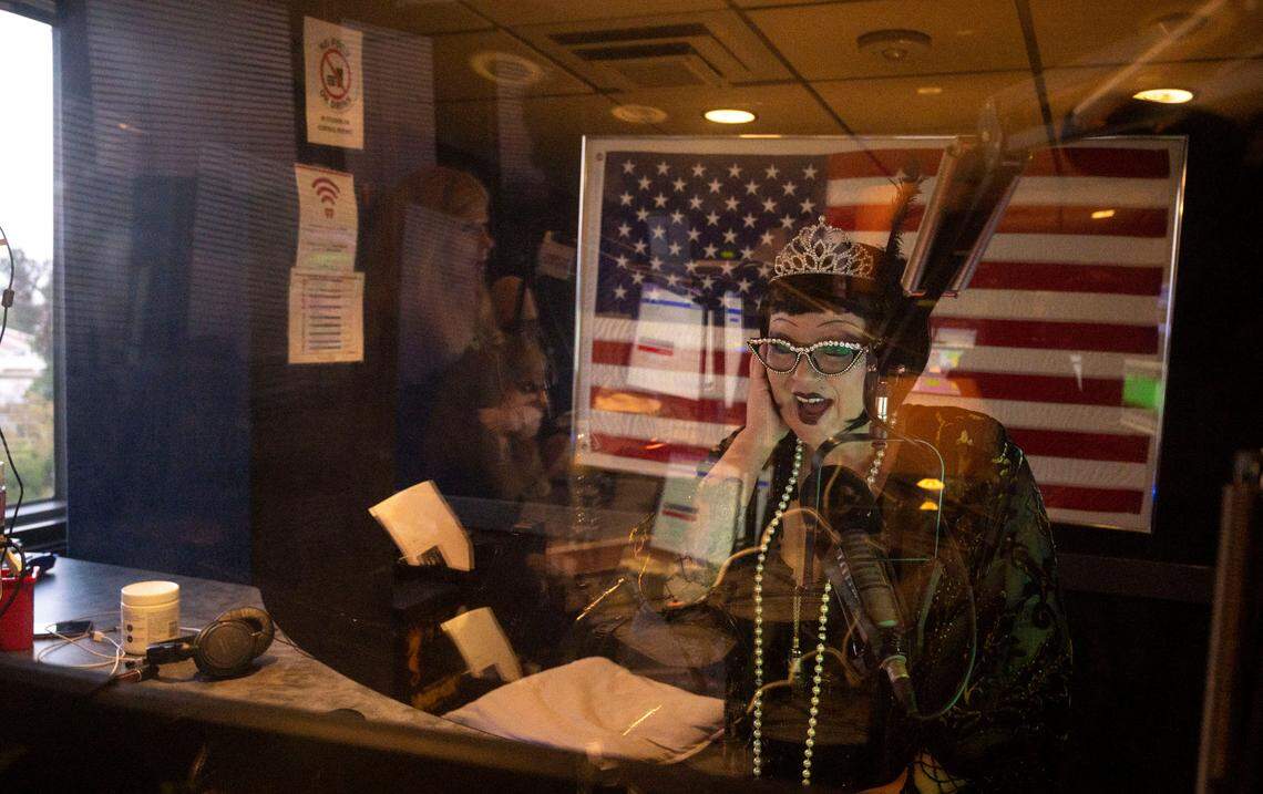 Dressed to resemble a 1920s flapper girl in honor of KFBK’s 100-year anniversay, technical producer Kendall Tobe reacts to the anchors from the control room during the Pat Walsh Show’s special radio broadcast Friday, Sept. 16, 2022, at iHeart Radio in Sacramento.
