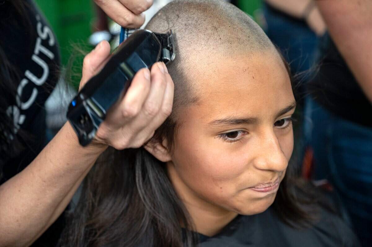 Karyn Sprague, 11, has her head shaved during the St. Baldrick’s event hosted by Mulvaney’s B&L and the de Vere’s Family in partnership with Keatons Childhood Cancer Alliance on Monday.