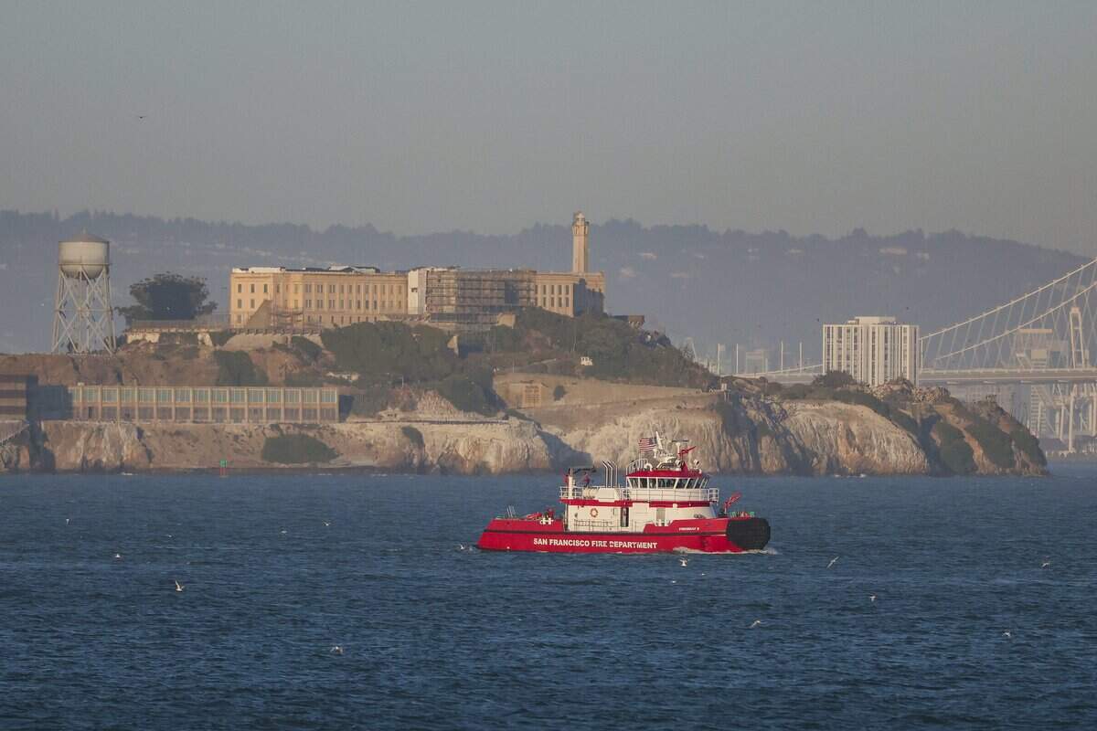 A San Francisco Fire Department boat searches near Alcatraz for two missing individuals after a boat capsized Tuesday in San Francisco. At least one person has died and three others remained missing as of Wednesday afternoon according to the U.S. Coast Guard.