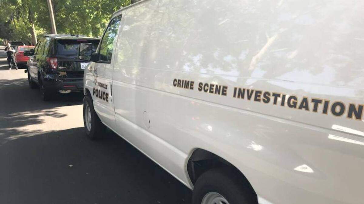 Officers with the Vacaville Police Department investigate the killing of a young woman shot dead in a residential garage Sunday morning, according to the police department.