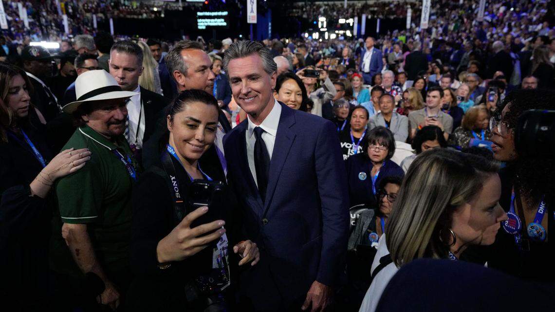 California Gov. Gavin Newsom poses for a photo with an attendee during the second day of the Democratic National Convention at the United Center in Chicago on Tuesday, Aug 20, 2024.