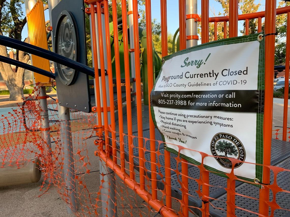 Plastic fencing wraps the play structure in Paso Robles’ Downtown City Park, and a sign alerts kids that it’s closed due to COVID-19 restrictions. New state guidelines allow playgrounds to reopen under all coronavirus risk tiers.