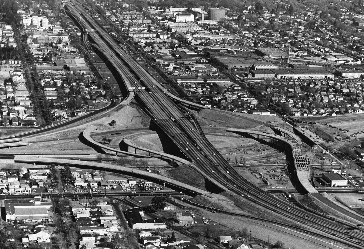 Workers build the Sacramento interchange connecting Highway 50, Highway 99, bottom, and the 29th-30th freeway, top, in January 1968. 