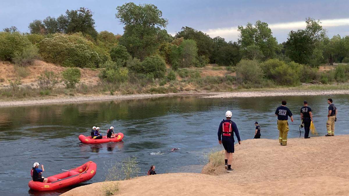 Search and rescue teams look for a missing boy in the American River near Rancho Cordova on Saturday, May 15, 2021.