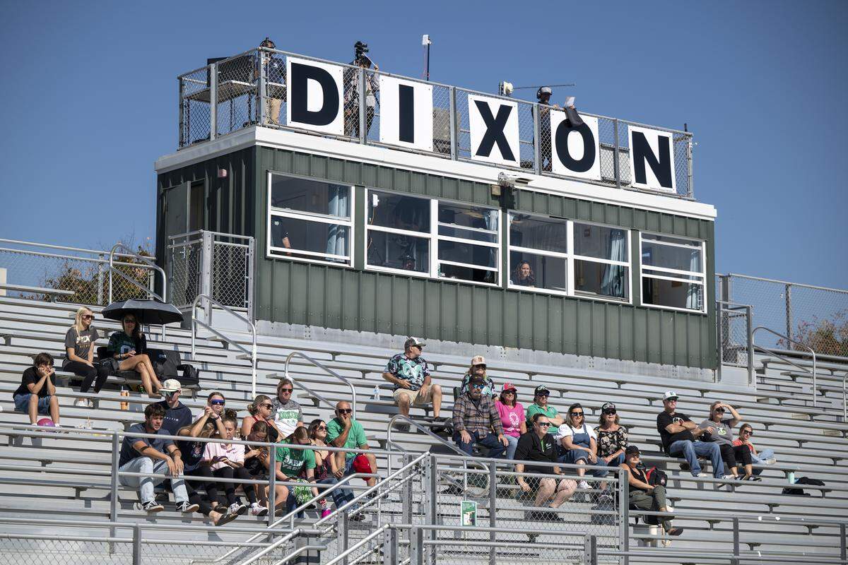 Fans watch a varsity football game between Dixon and Casa Roble in Dixon on Saturday. The game, rescheduled from the night before, follows the death of a Dixon junior varsity football player