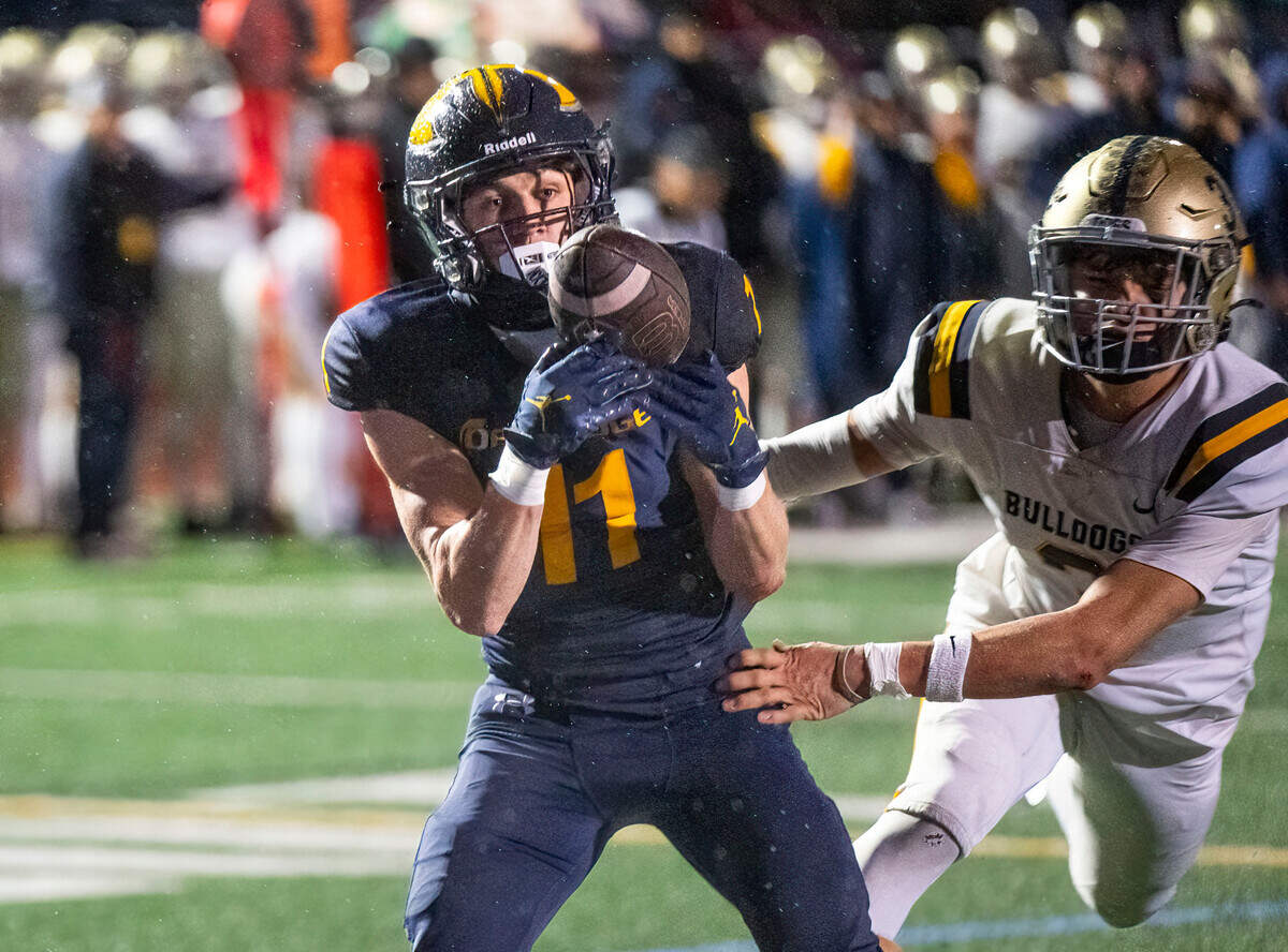 Oak Ridge Trojans receiver Issac Pierce (11) makes a 23-yard touchdown catch in the first half as the Turlock Bulldogs’ Leo Contreras (3) defends in a Sac-Joaquin Section semifinal playoff game in 2024. 