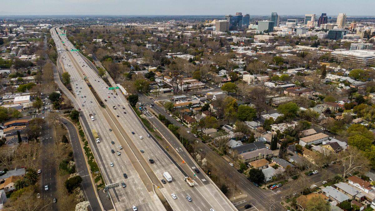 Cars drive on the W-X segment of Highway 50 through Sacramento on March 22, 2021, the day Caltrans formally launched a $460 million project that would add carpool lanes by filling in the gap between the eastbound and westbound lanes. Officials said this week that eastbound lanes would no longer be split as it closes in on completion.