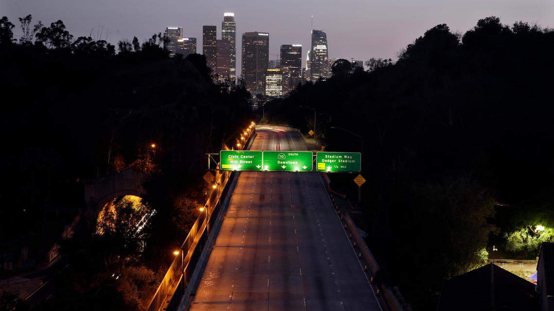 In this April 2, 2020, file photo, light traffic is seen on the 110 freeway with the city skyline in the background in Los Angeles. California.