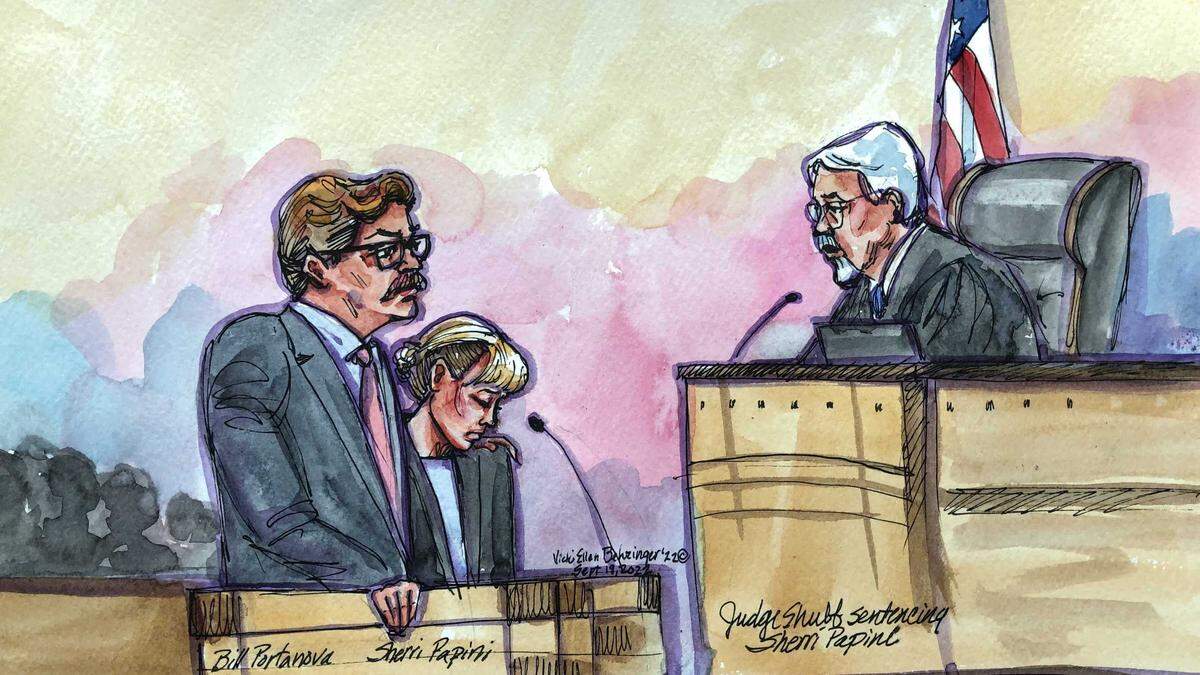 Sherri Papini, center, is seen in a courtroom sketch in Sacramento on Monday, Sept. 19, 2022. The 40-year-old Shasta County woman, seen with her attorney William Portanova, listens as Senior U.S. District Judge William B. Shubb, right, sentences her to 18 months in federal prison for fabricating her 2016 kidnapping.