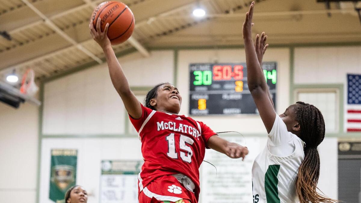McClatchy Lions guard Tamaria Rumph (15), left, scores against Monterey Trail in January.