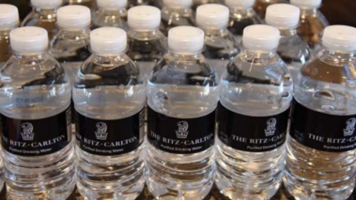 A Ritz-Carlton hotel guest says an employee served a contaminated water bottle “defiled with semen,” according to a federal lawsuit.