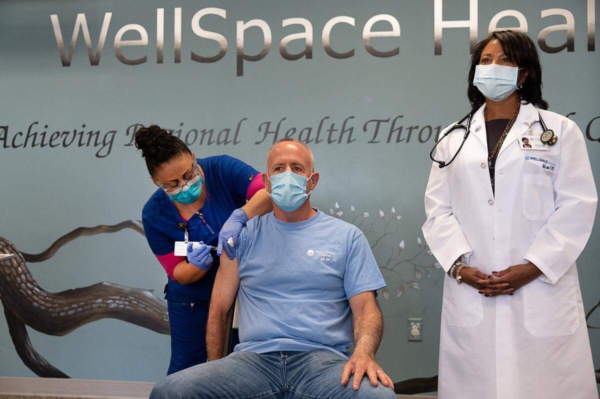 Sacramento Mayor Darrell Steinberg receives the Johnson & Johnson COVID-19 vaccine from medical assistant Silvia Zuniga with Dr. Janine Bera at Wellspace Health in Sacramento on April 1, 2021.