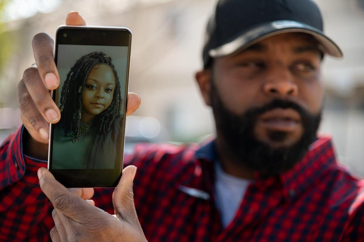 Ryan Vickers holds a cellphone on Friday showing a photograph of his sister Mishila Vickers. She went into the Sacramento jail in December on a failure to appear charge and ended up in a catatonic state with COVID-19 and broken ribs.