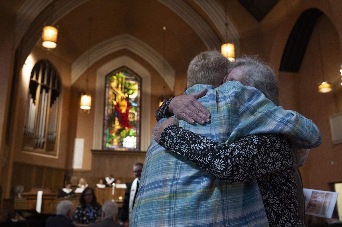 Raymond Graetz hugs Barbara Renzi before the final service of Pioneer Congregational United Church of Christ at their church on L Street in Sacramento on Sunday, May 31, 2026.