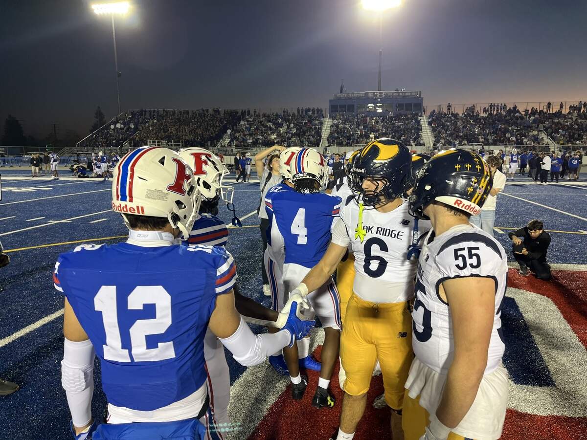 Team captains for Folsom and Oak Ridge meet at midfield before kickoff on Friday. Folsom won 28-9 at home.
