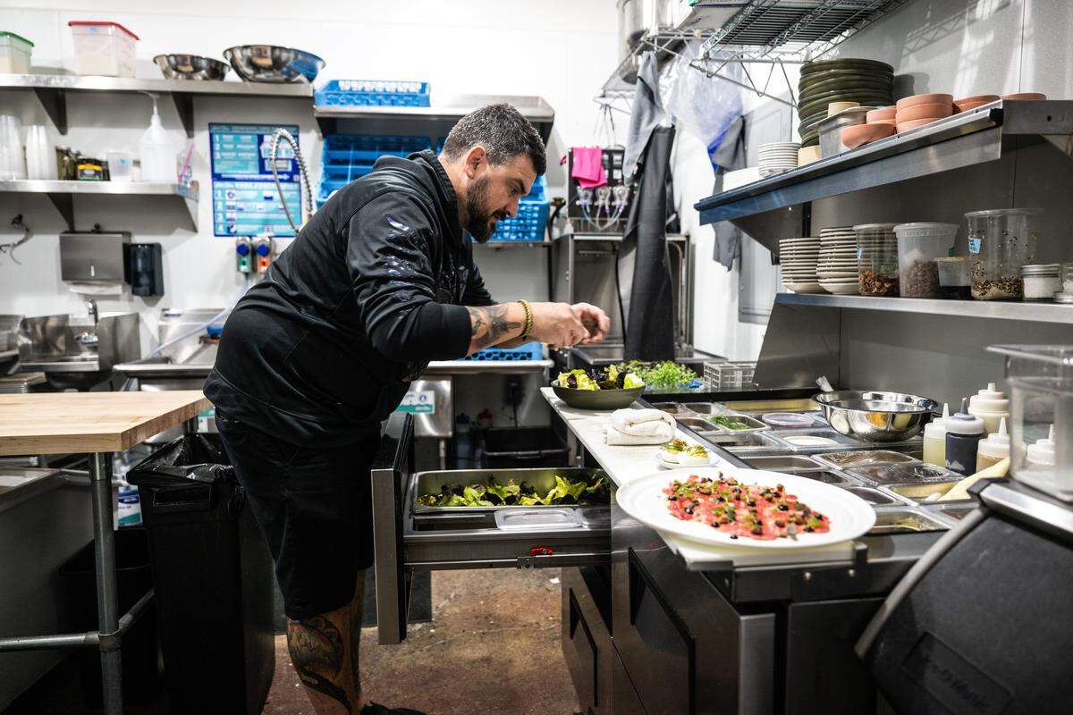 Chris Barnum-Dann, the owner of Betty Wine Bar & Bottle Shop in Southside Park, prepares a Betty salad on Thursday, Jan. 9, 2025. Barnum-Dann, the chef and owner of the Michelin-starred Localis restaurant, took over the bistro in December 2024.