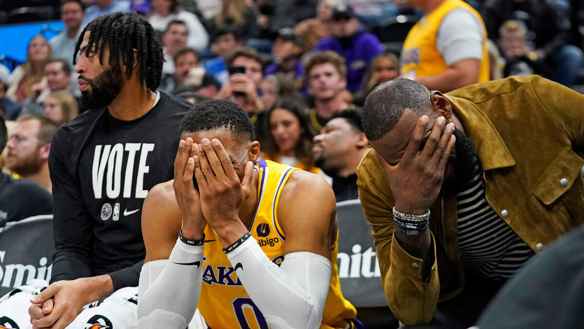 Los Angeles Lakers’ Anthony Davis, left, Russell Westbrook (0) and LeBron James sit on the bench near the end of the fourth quarter of the team’s NBA basketball game against the Utah Jazz on Monday, Nov. 7, 2022, in Salt Lake City. (AP Photo/Rick Bowmer)