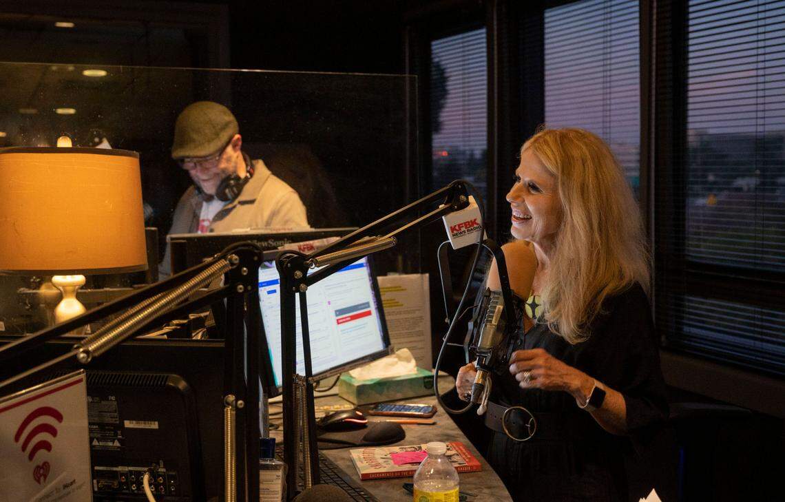 Newsradio KFBK anchors Pat Walsh, left, and Kitty O’Neal talk on air Friday, Sept. 16, 2022, about the 100-year anniversary of the news radio station that launched on Sept. 17, 1922. KFBK is Sacramento’s longest running radio broadcasting station.